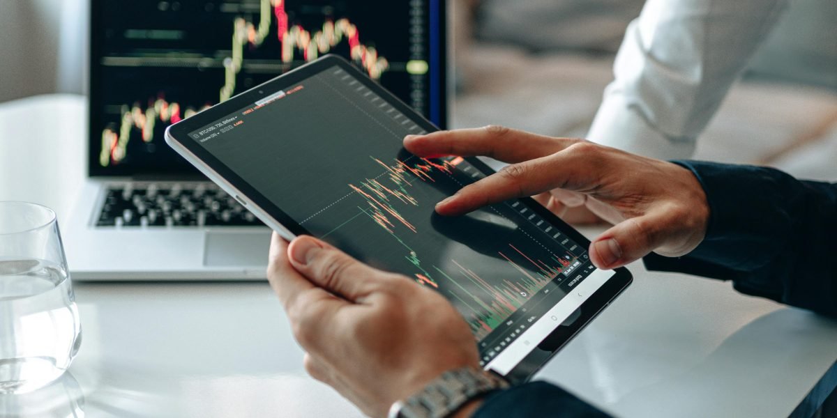 An investor reviewing documents and data, contemplating strategic property decisions with the help of predictive analytics.