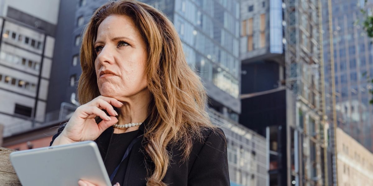 An investor thoughtfully considering the optimal timing for a real estate investment.
