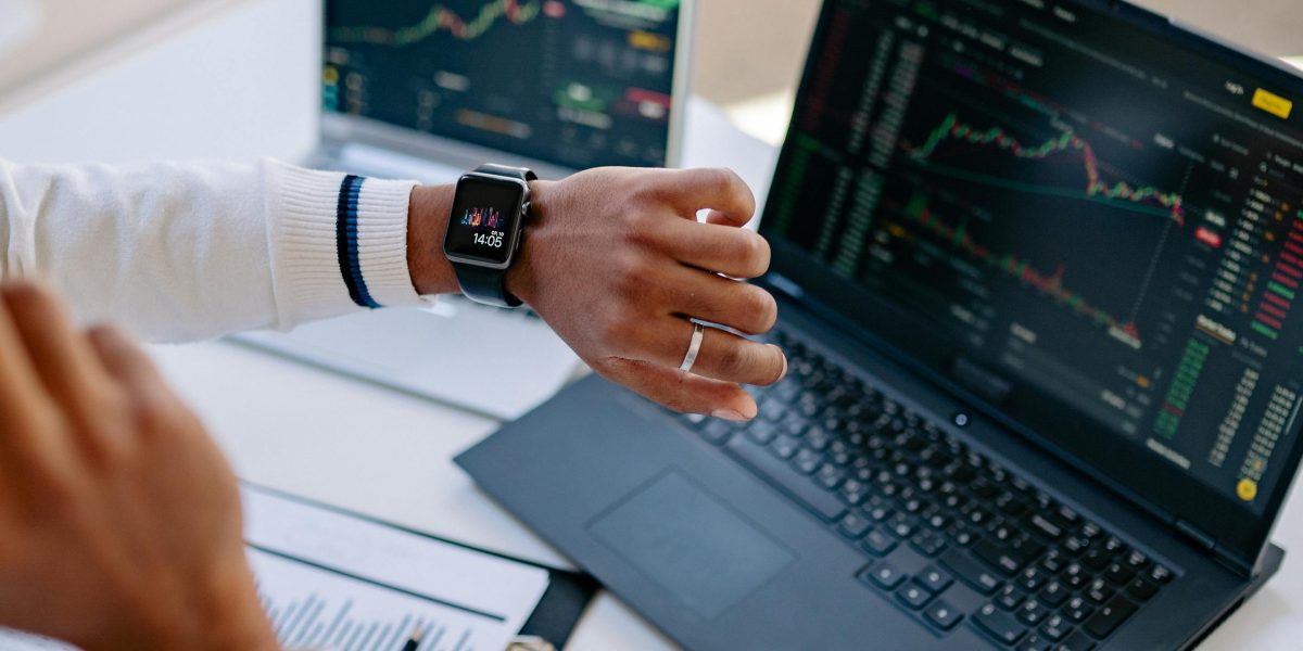 A business professional confidently analyzing charts and data to understand market cycles.