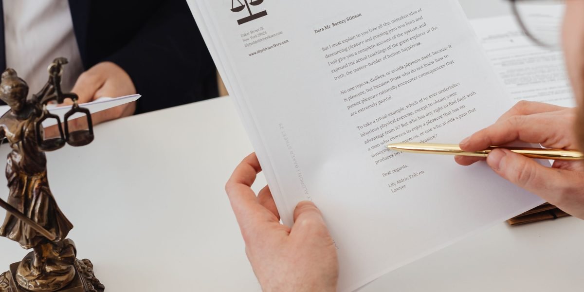Two professionals discussing legal documents related to property regulations.