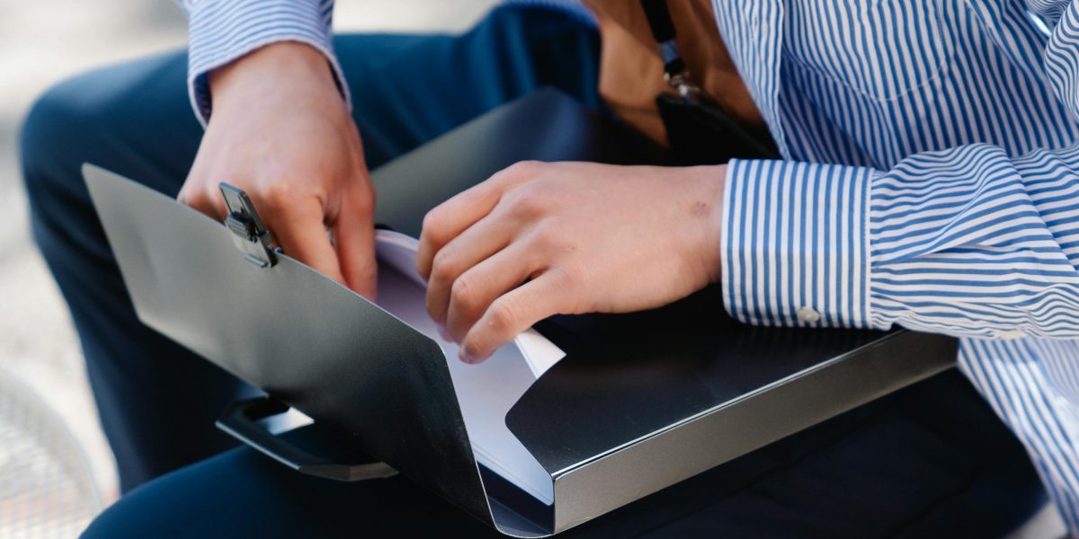 An individual investor diligently reviewing market documents and reports in a focused, relaxed environment.