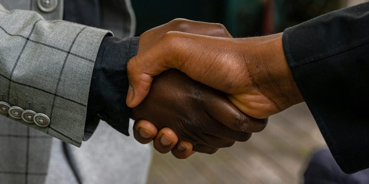 Professionals shaking hands, symbolizing a successful partnership or a confident business agreement made with data-driven insights.