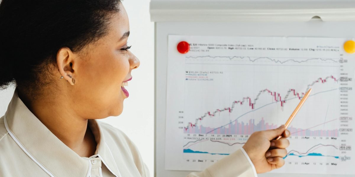 A data analytics business analyst communicates complex market insights to stakeholders, simplifying data for decision-making.