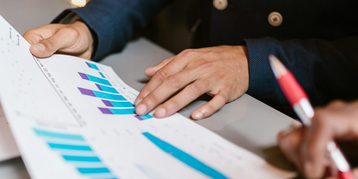 An investor thoughtfully reviewing property valuation data and market indicators, preparing to make an informed investment decision.