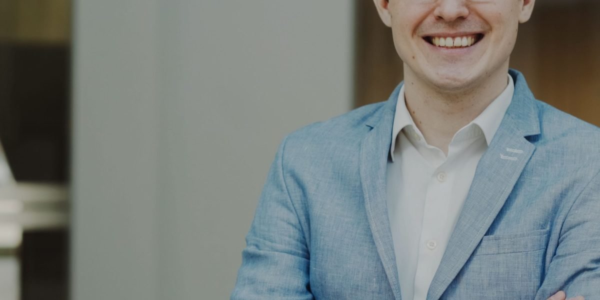 A confident professional smiles, reflecting the newfound certainty and success achieved through data analytics skills.