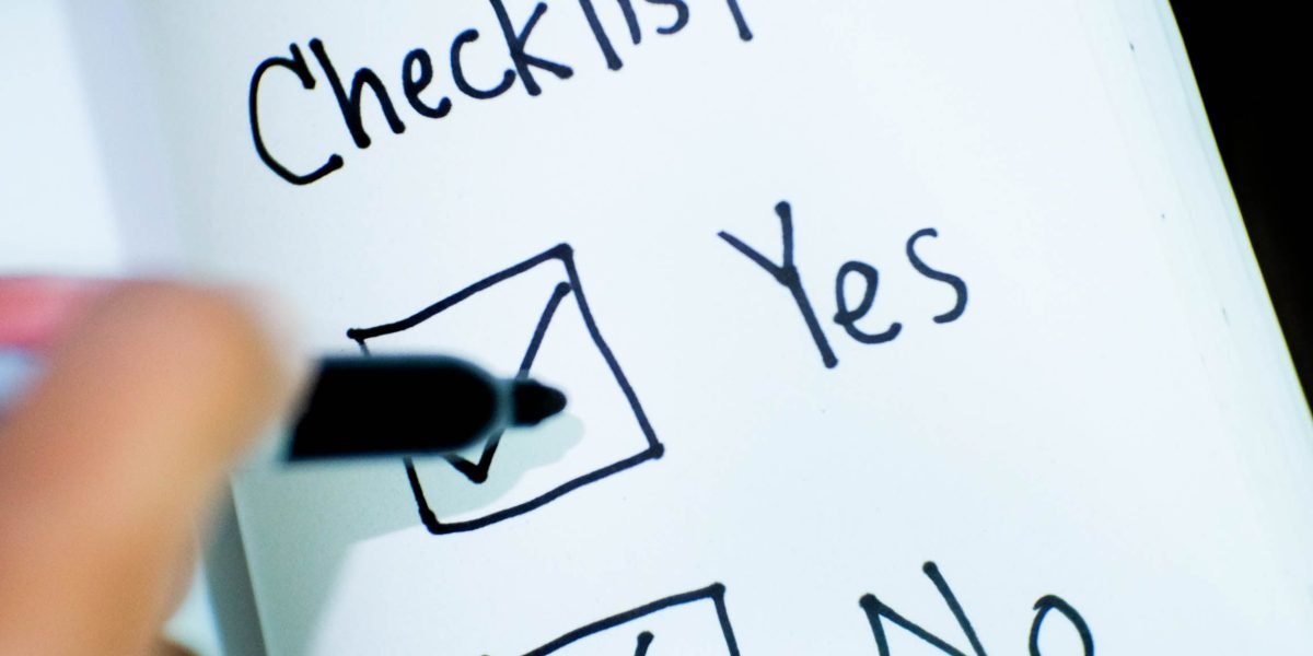 A person reviewing a checklist or documents, representing the careful evaluation of course quality and career choices.